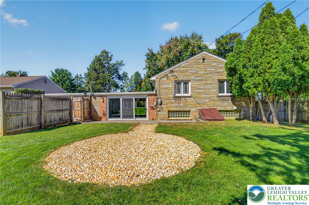 1814 Ruth Street Allentown, PA 18104 - Photo 50 of 54 A spacious grassy lawn sits behind this classic stone-sided home featuring a sliding glass door.