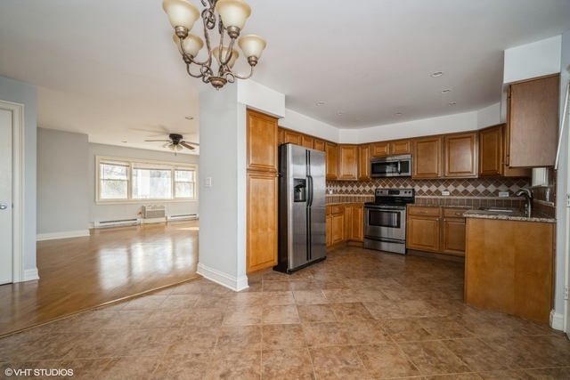 1345 1st Street, Unit 1345 Northbrook, IL 60062 - Photo 3 of 10 a kitchen with stainless steel appliances granite countertop a stove refrigerator and microwave