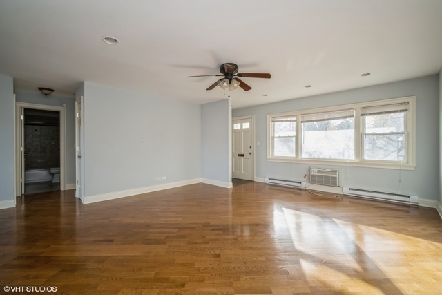 1345 1st Street, Unit 1345 Northbrook, IL 60062 - Photo 4 of 10 a view of empty room with wooden floor and fan
