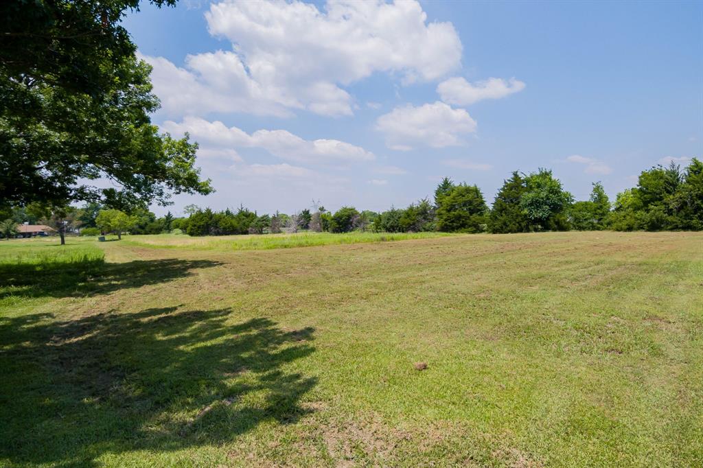 7 Greenfield Way Lucas, TX 75098 - Photo 2 of 16 View of grassy yard featuring a rural view