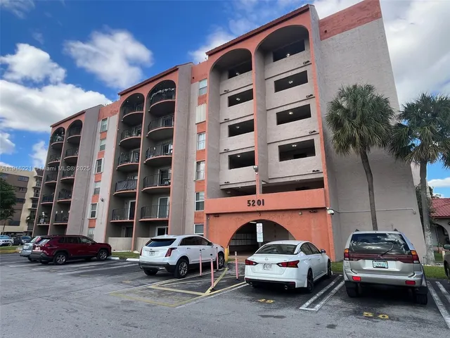 a view of cars parked in front of a building