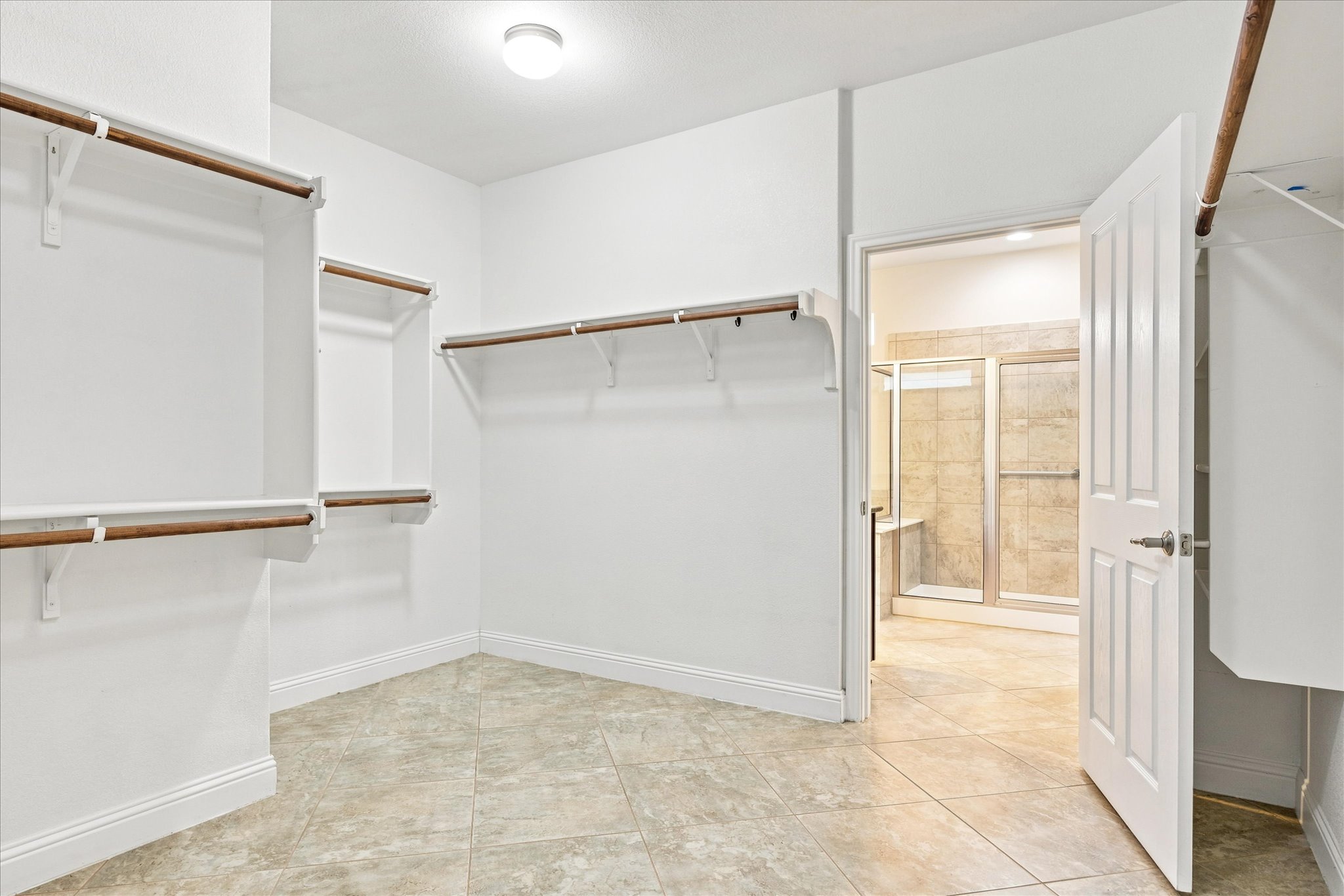 103 McKittrick Ridge Road Georgetown, TX 78633 - Photo 14 of 23 Ample built-in shelving and tile flooring define this spacious closet space.
