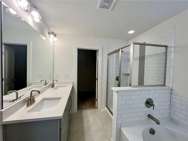 a bathroom with a sink toilet vanity and shower