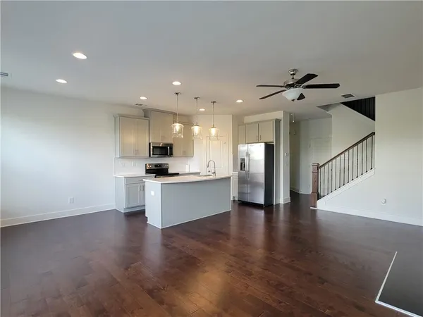 a view of kitchen with sink and refrigerator