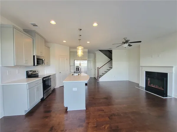 a view of kitchen with cabinets and wooden floor