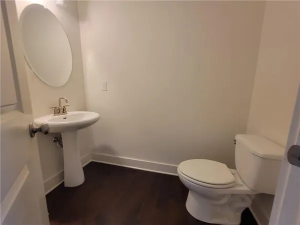 a bathroom with a sink toilet and a mirror