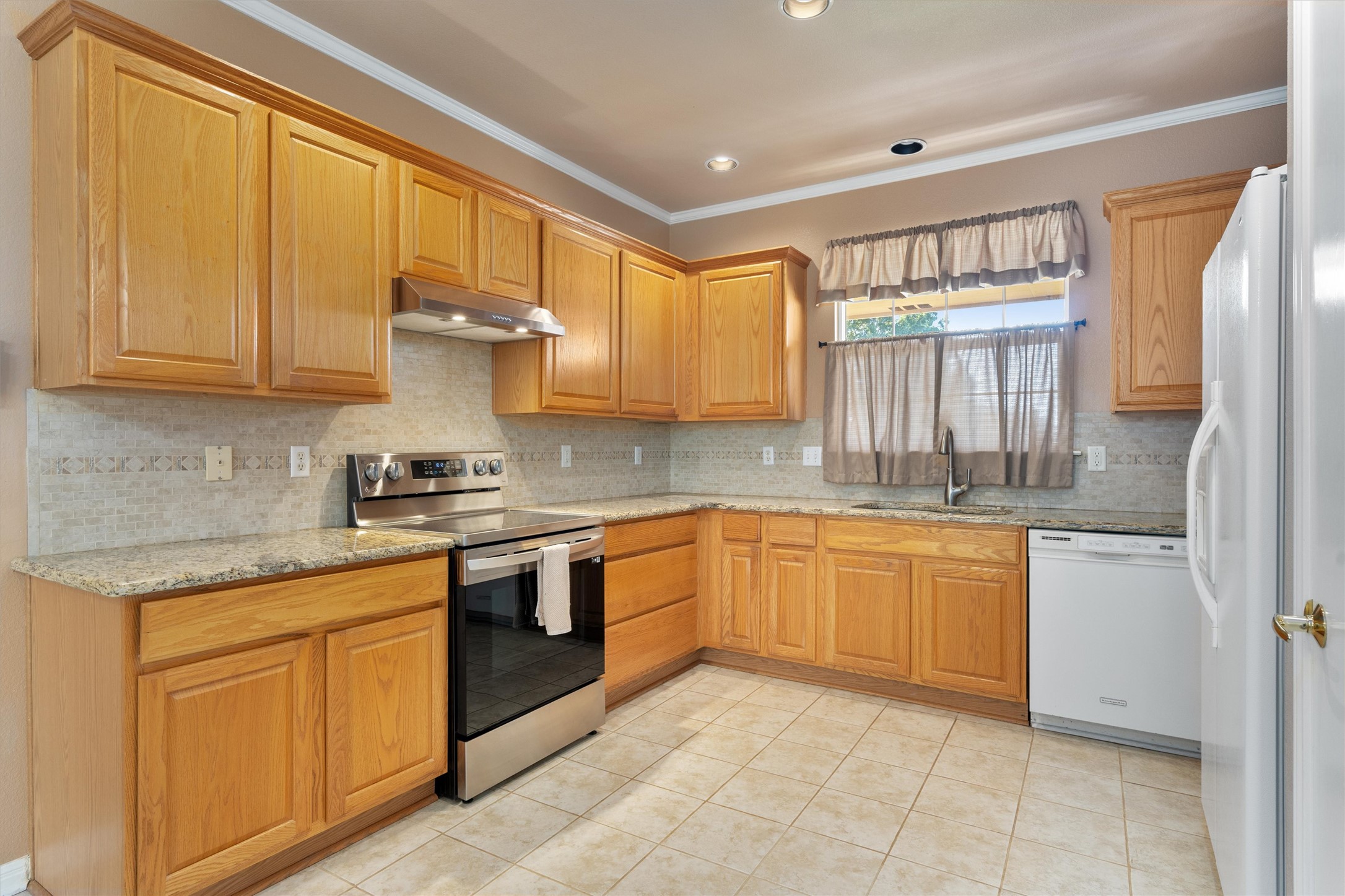 272 Red Poppy Trail Georgetown, TX 78633 - Photo 11 of 29 a kitchen with stainless steel appliances granite countertop a sink and cabinets