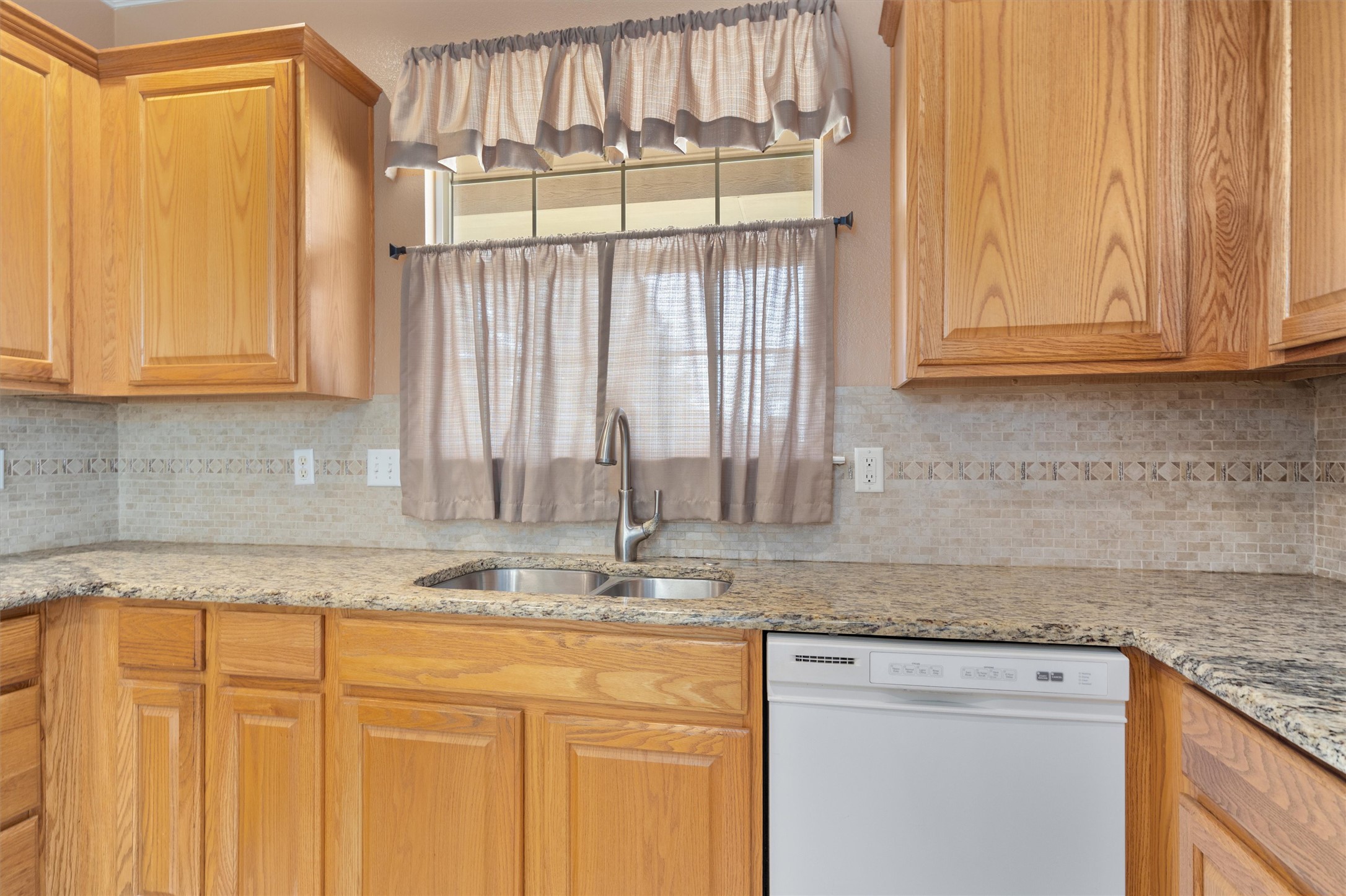 272 Red Poppy Trail Georgetown, TX 78633 - Photo 13 of 29 a kitchen with granite countertop a sink window and cabinets