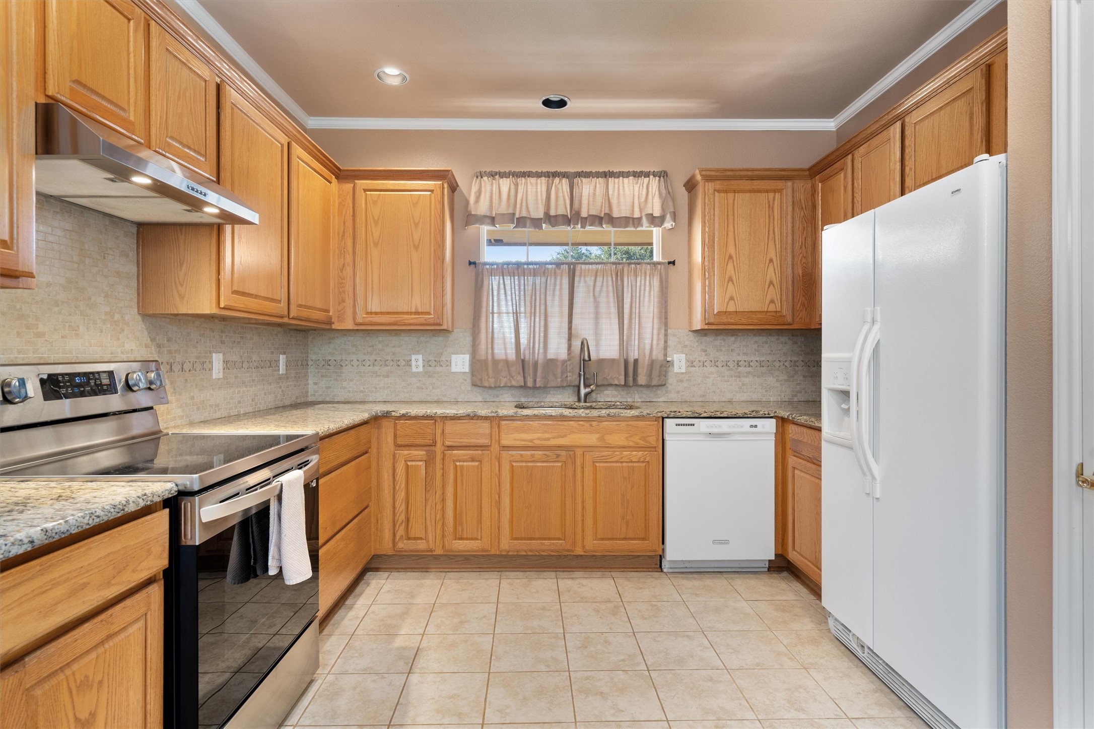 272 Red Poppy Trail Georgetown, TX 78633 - Photo 10 of 29 a kitchen with stainless steel appliances granite countertop a refrigerator and a stove top oven