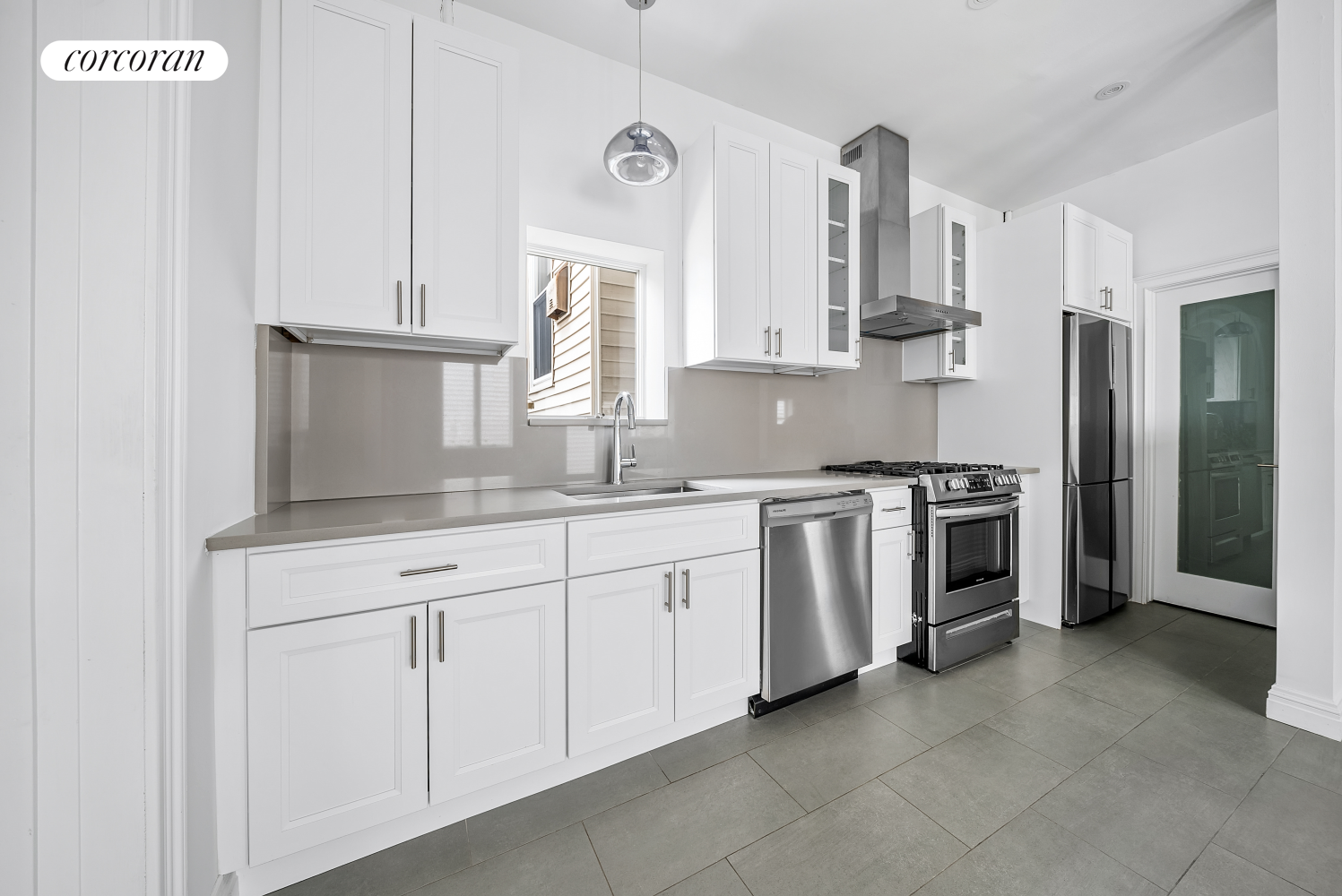 a kitchen with stainless steel appliances white cabinets and a sink