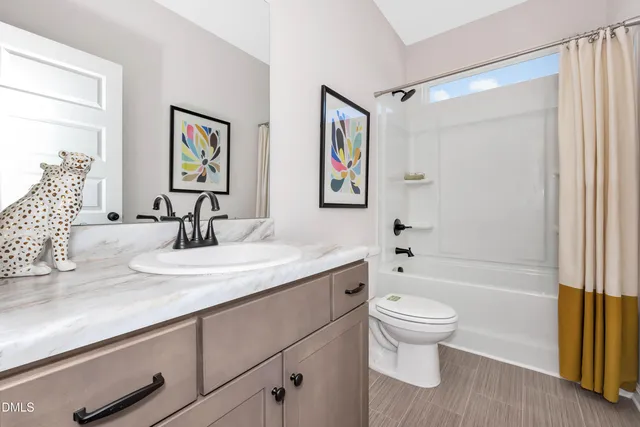 a bathroom with a granite countertop sink toilet and a bathtub