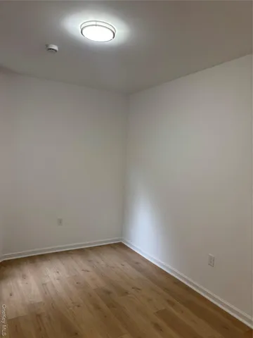 a view of an empty room and wooden floor