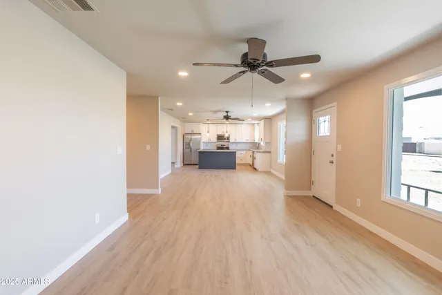 a view of a living room hardwood floor and a window