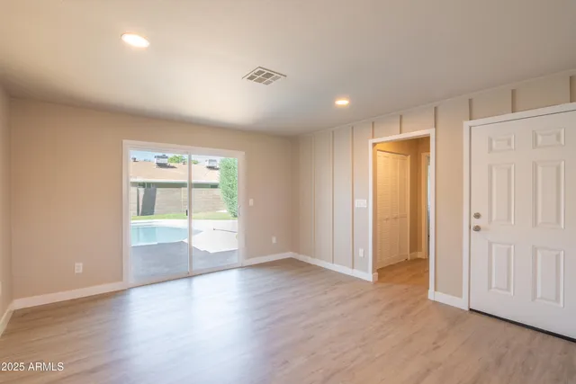 wooden floor in an empty room with a window