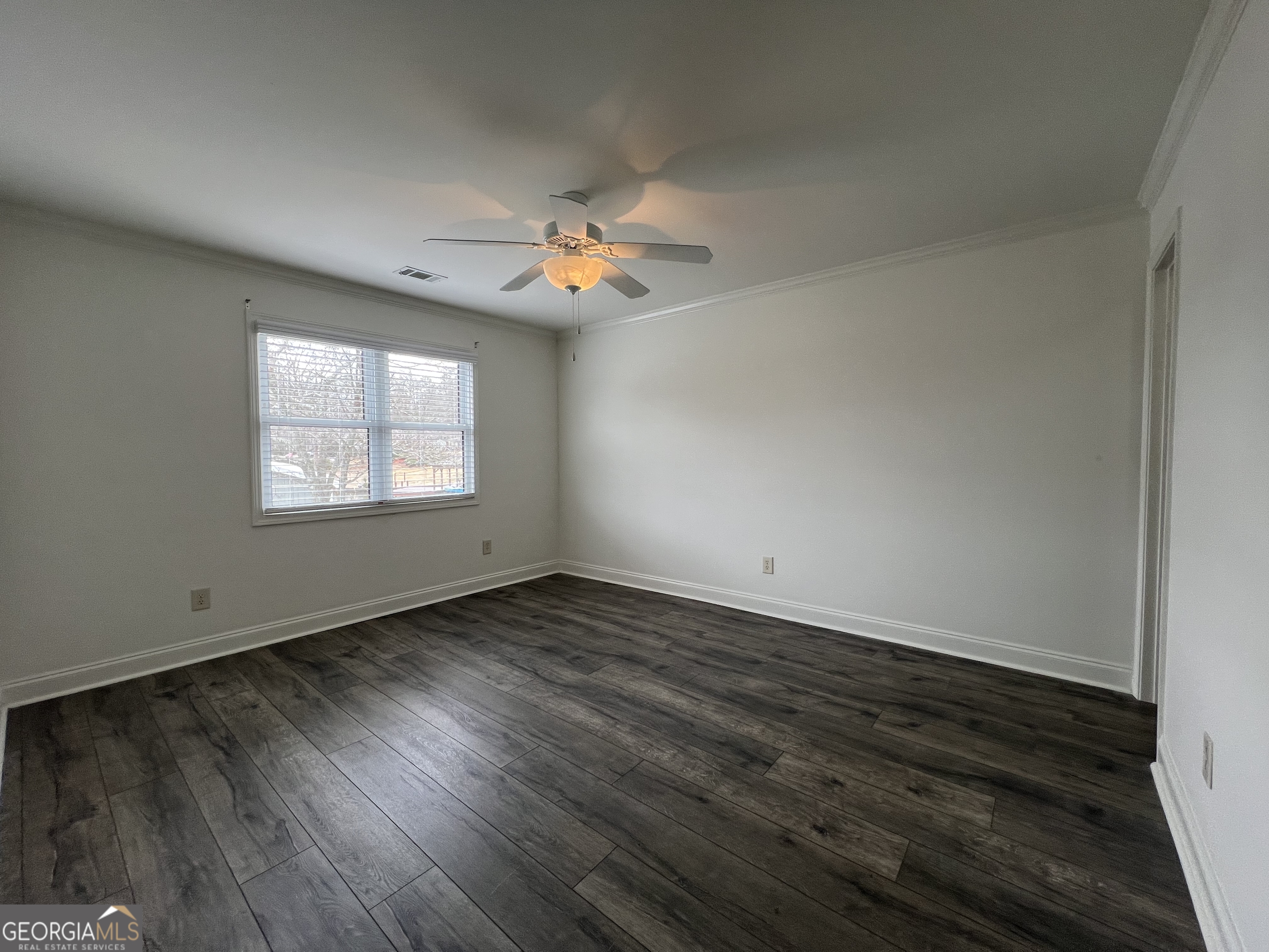 166 Montego Bay Road Northwest Milledgeville, GA 31061 - Photo 11 of 42 a view of an empty room with wooden floor and a window