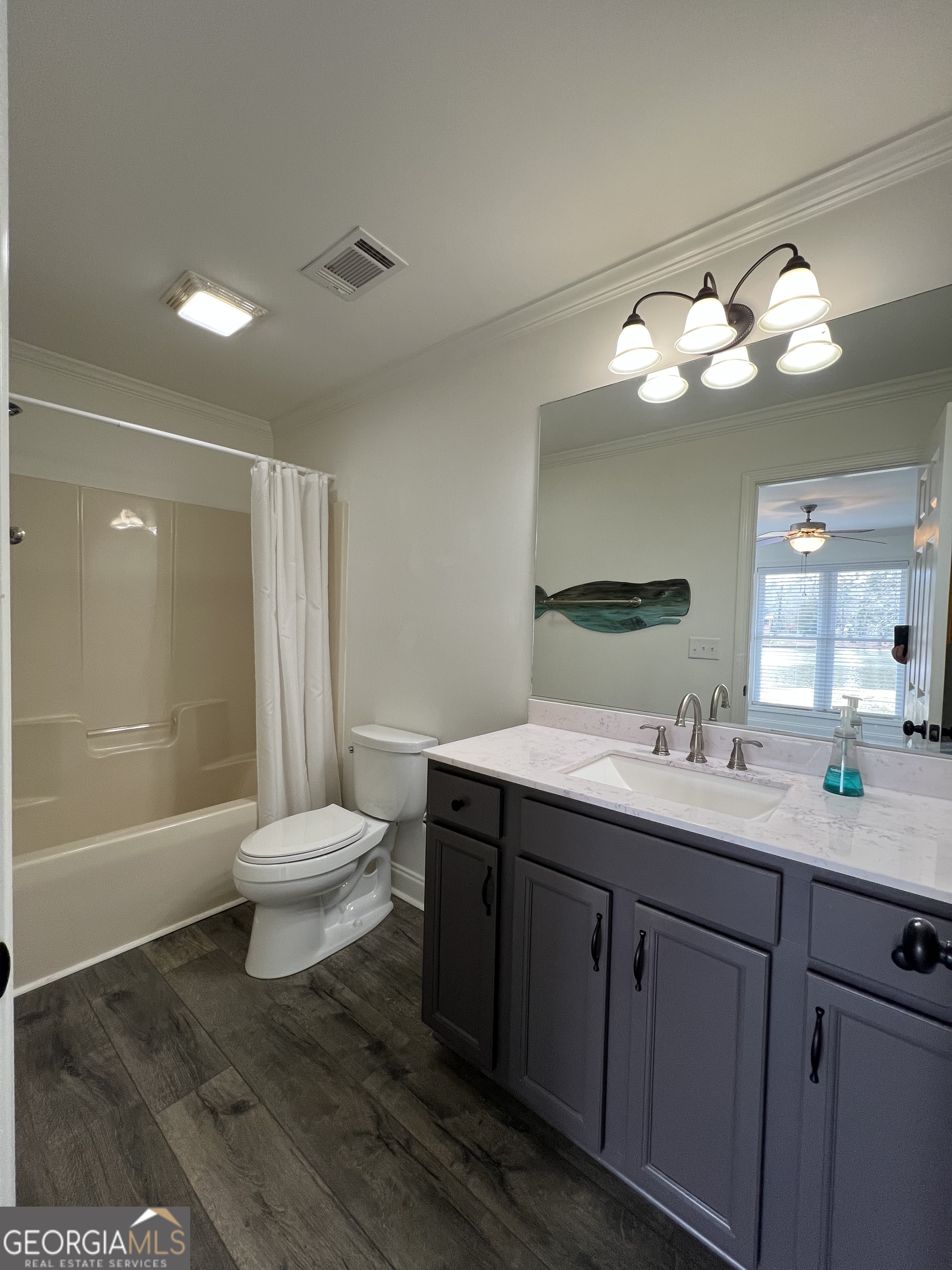 166 Montego Bay Road Northwest Milledgeville, GA 31061 - Photo 17 of 42 a bathroom with a sink a toilet and a large mirror