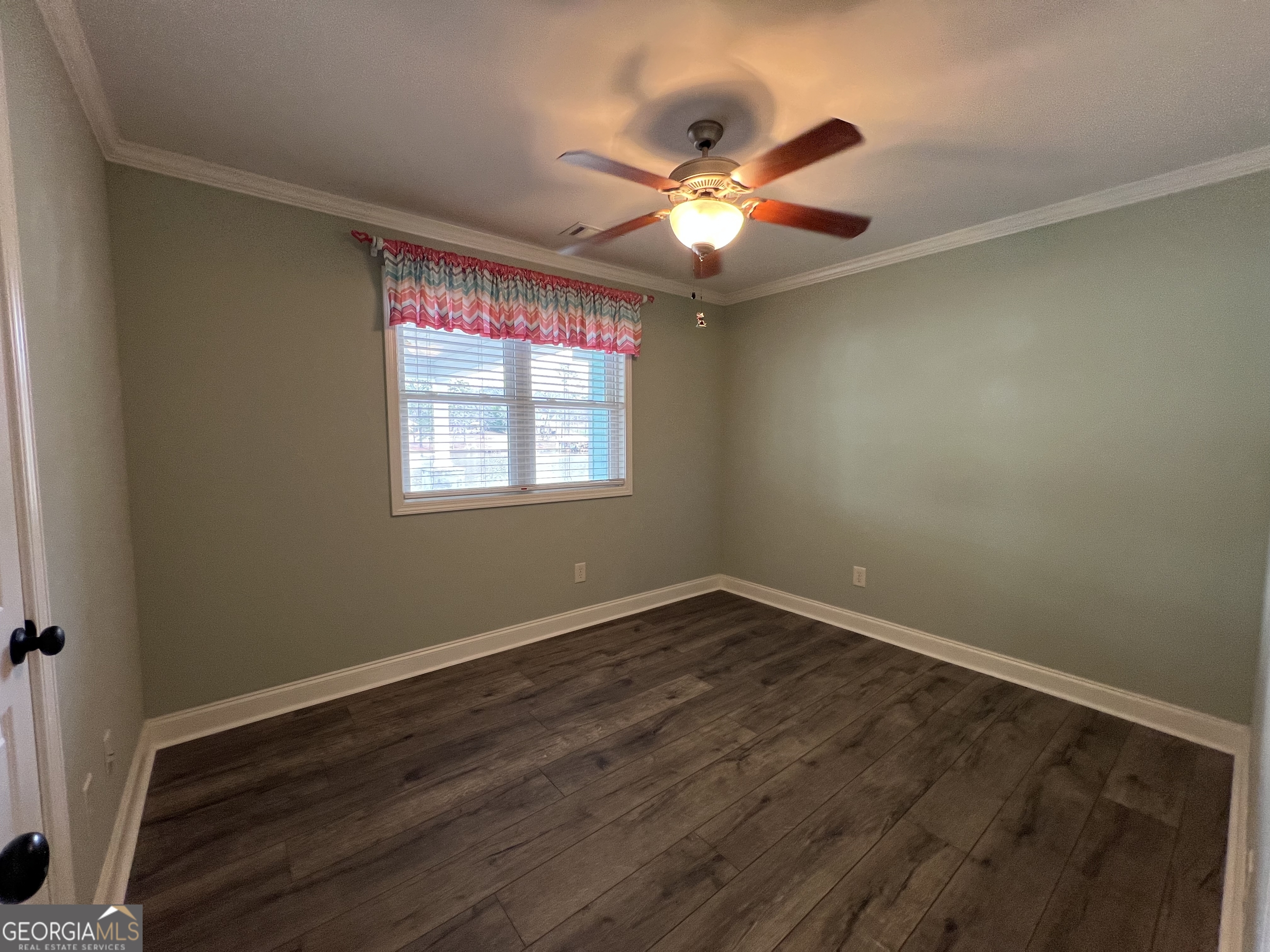 166 Montego Bay Road Northwest Milledgeville, GA 31061 - Photo 18 of 42 a view of an empty room with wooden floor and a window