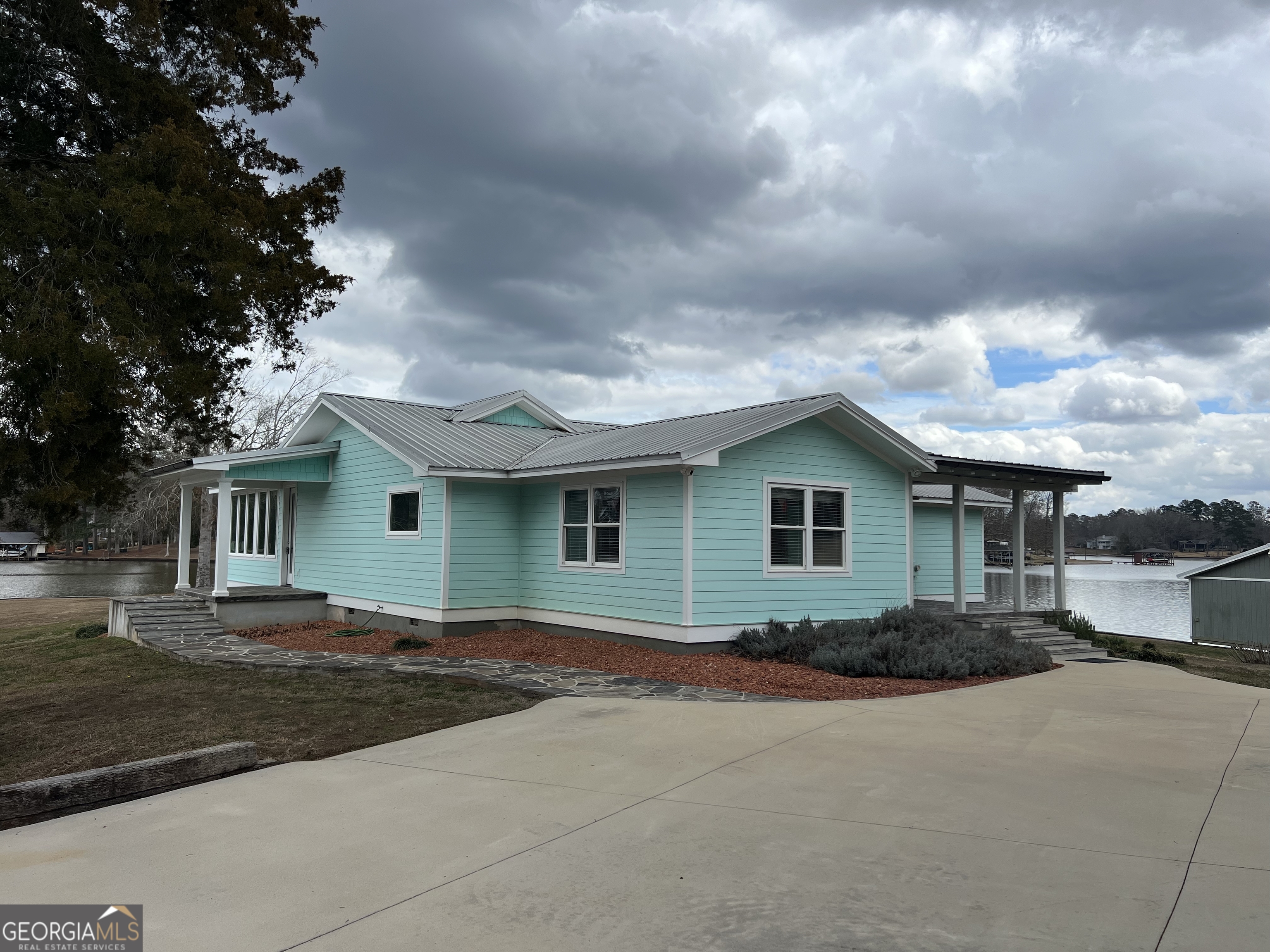166 Montego Bay Road Northwest Milledgeville, GA 31061 - Photo 2 of 42 a front view of a house with a garden