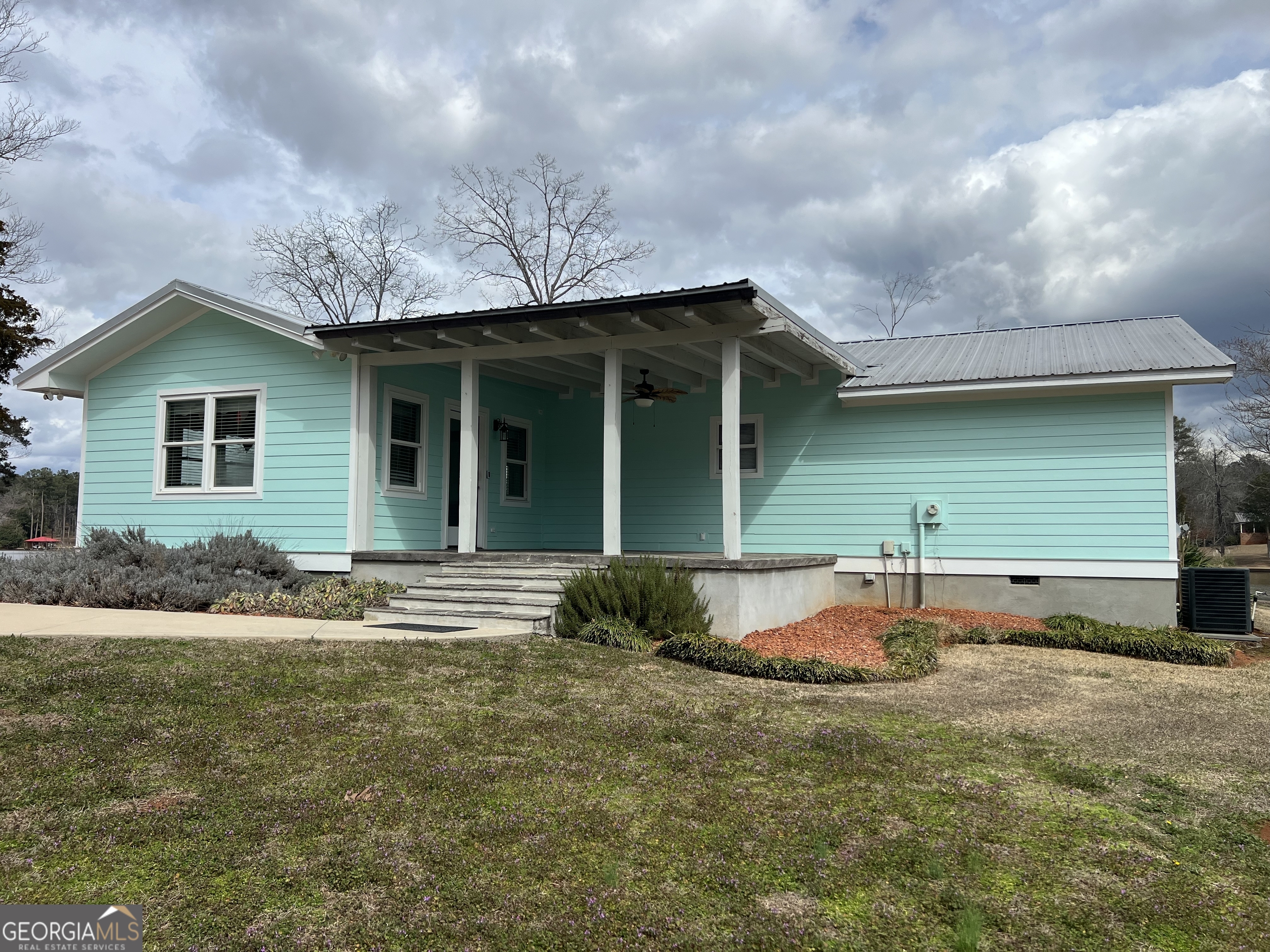 166 Montego Bay Road Northwest Milledgeville, GA 31061 - Photo 3 of 42 a front view of a house with garden