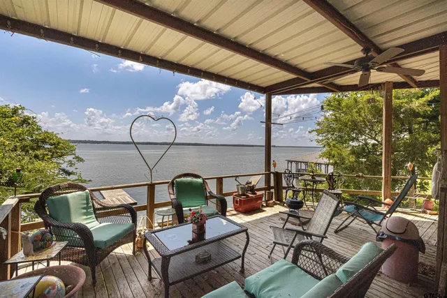 a bedroom with a bed dresser and a flat tv screen