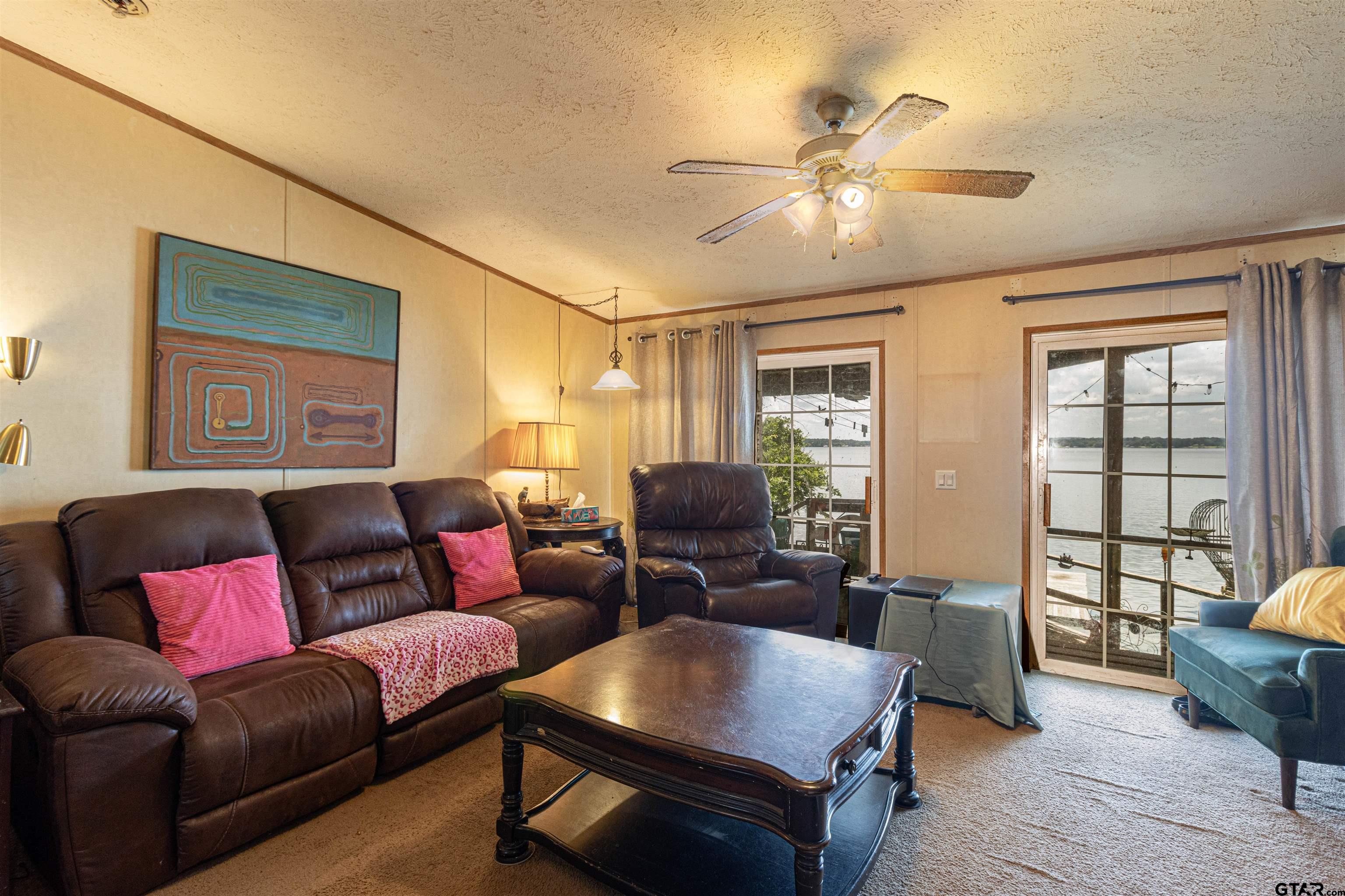 489 Martha Street Bullard, TX 75757 - Photo 27 of 44 a living room with furniture and a chandelier