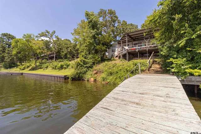 a living room with furniture ceiling fan and a window