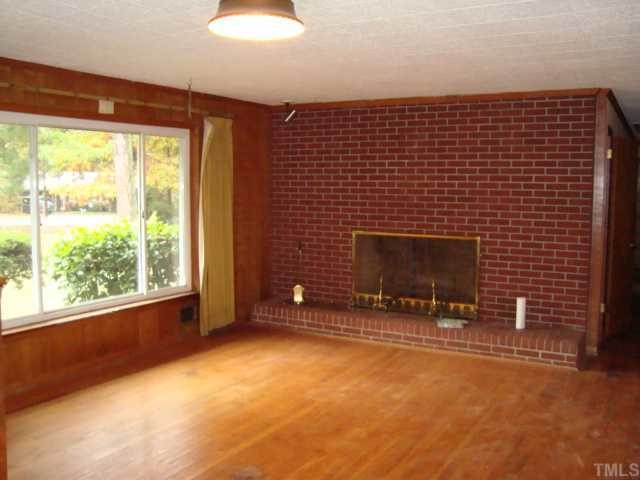 6414 King Lawrence Road Raleigh, NC 27607 - Photo 2 of 12 a view of an empty room with a fireplace and a window