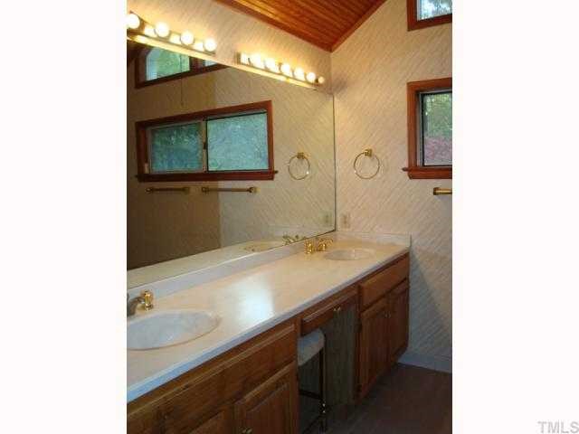 6414 King Lawrence Road Raleigh, NC 27607 - Photo 5 of 12 a bathroom with a sink and a mirror