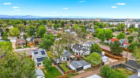 an aerial view of a house with a garden and swimming pool