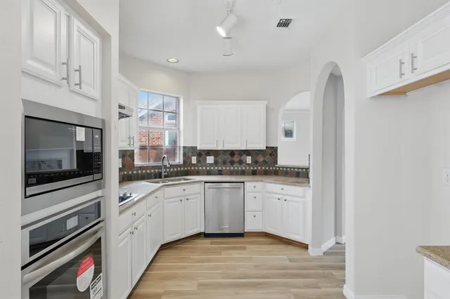 a kitchen with stainless steel appliances granite countertop a stove and a sink