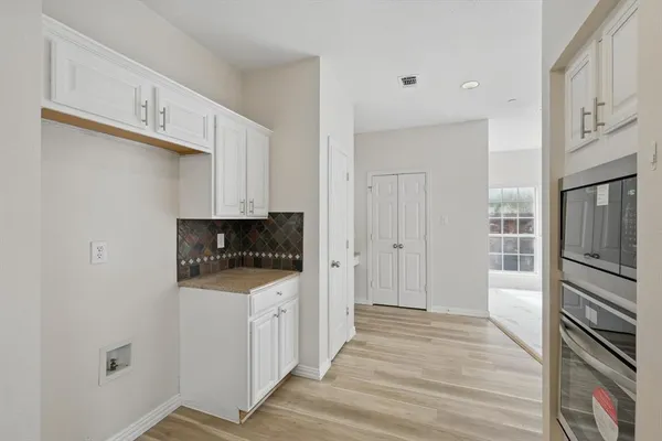 a kitchen with granite countertop a refrigerator and a stove top oven