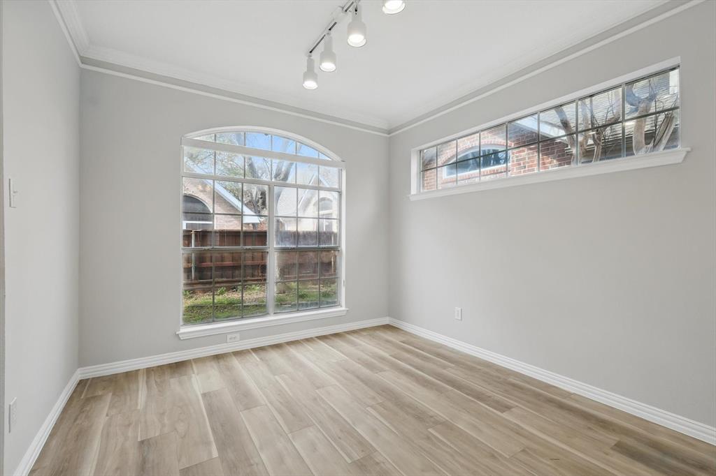 14625 Windsor Court Addison, TX 75001 - Photo 20 of 40 an empty room with wooden floor and windows