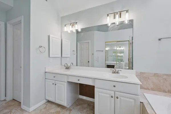 a bathroom with a sink vanity and a mirror