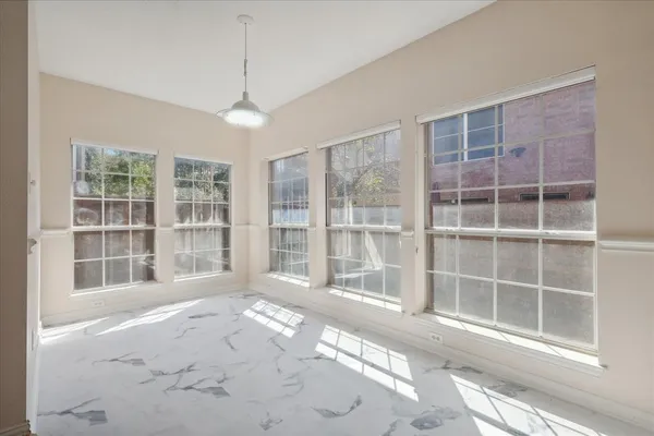 an empty room with windows and closet