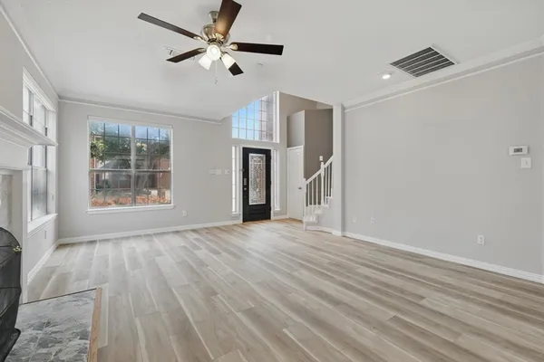 wooden floor in an empty room with a window