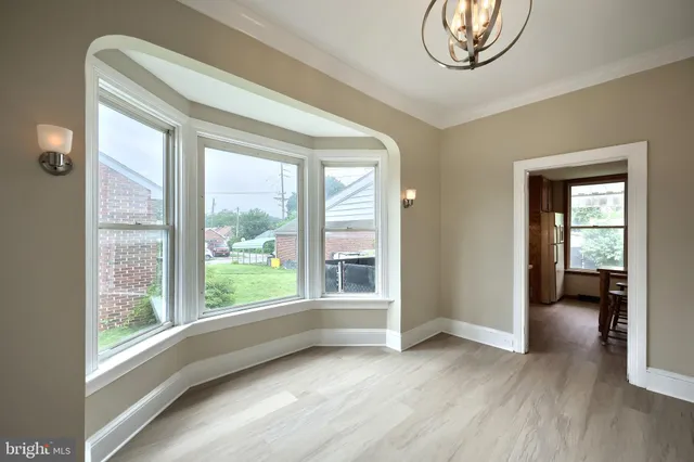 a view of a big room with windows and cabinet