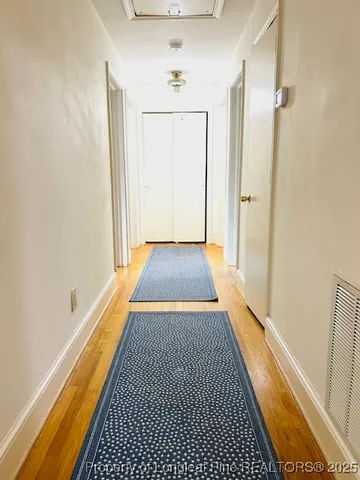 a view of a room with wooden floor