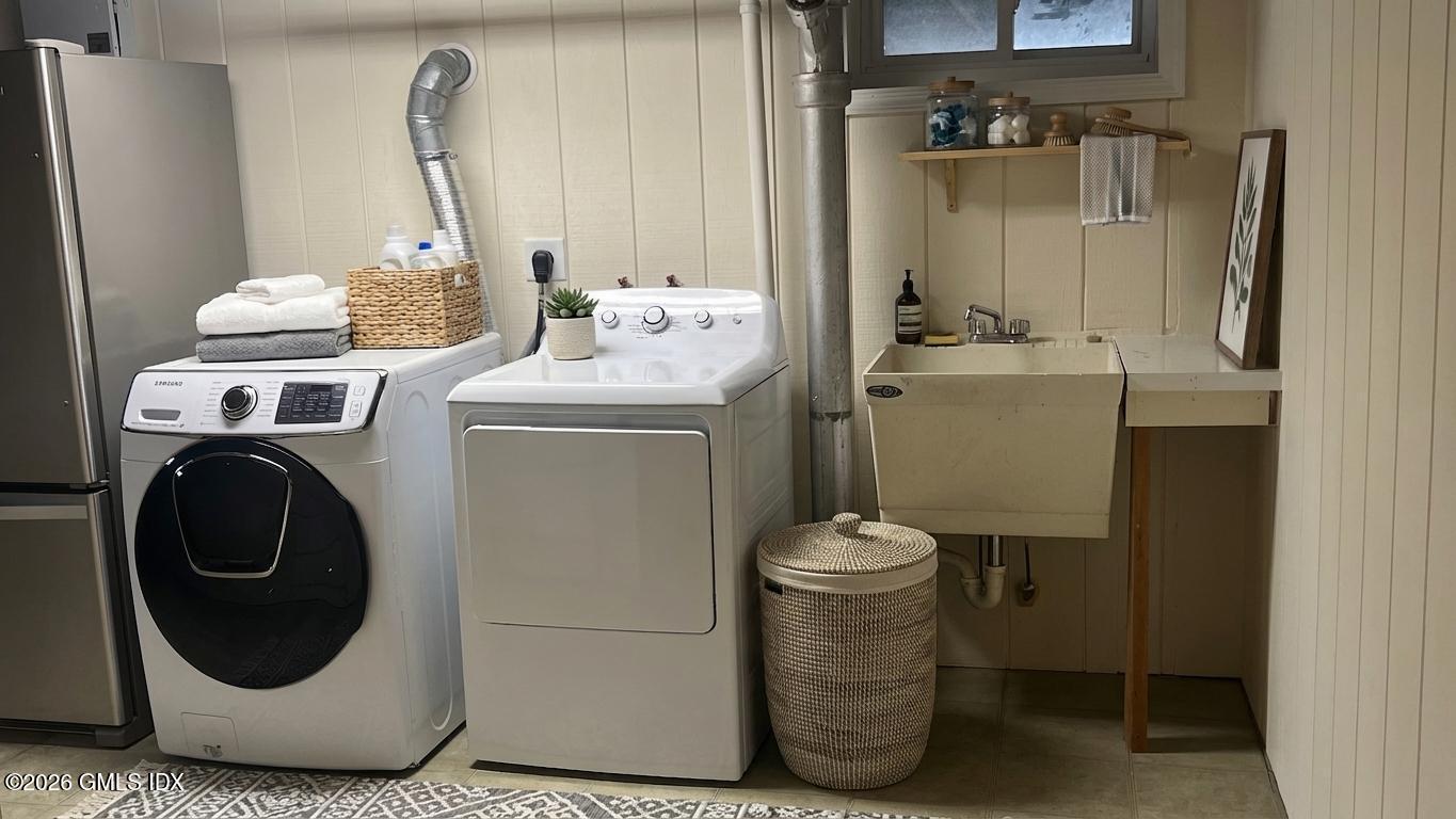 45 Sound Beach Ave Extension Riverside, CT 06878 - Photo 11 of 11 a utility room with dryer and washer