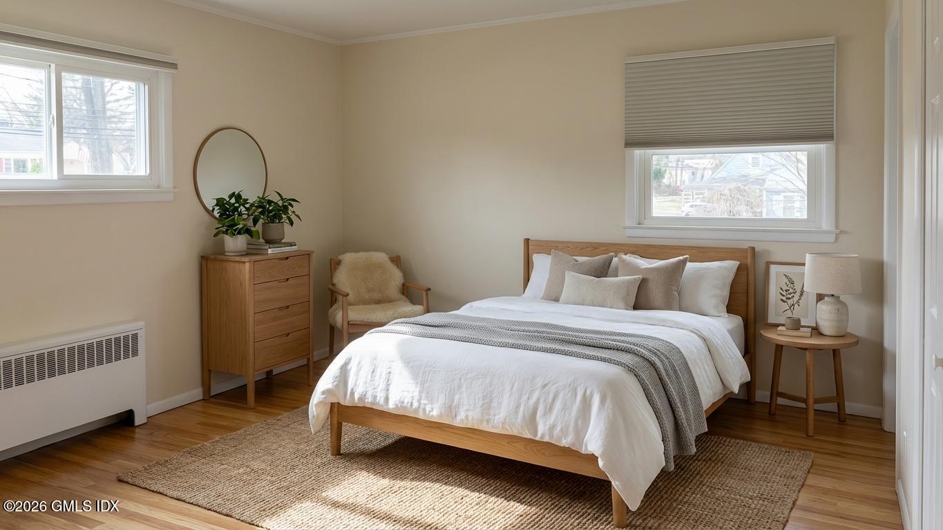 45 Sound Beach Ave Extension Riverside, CT 06878 - Photo 4 of 11 a bedroom with a bed a potted plant and a window