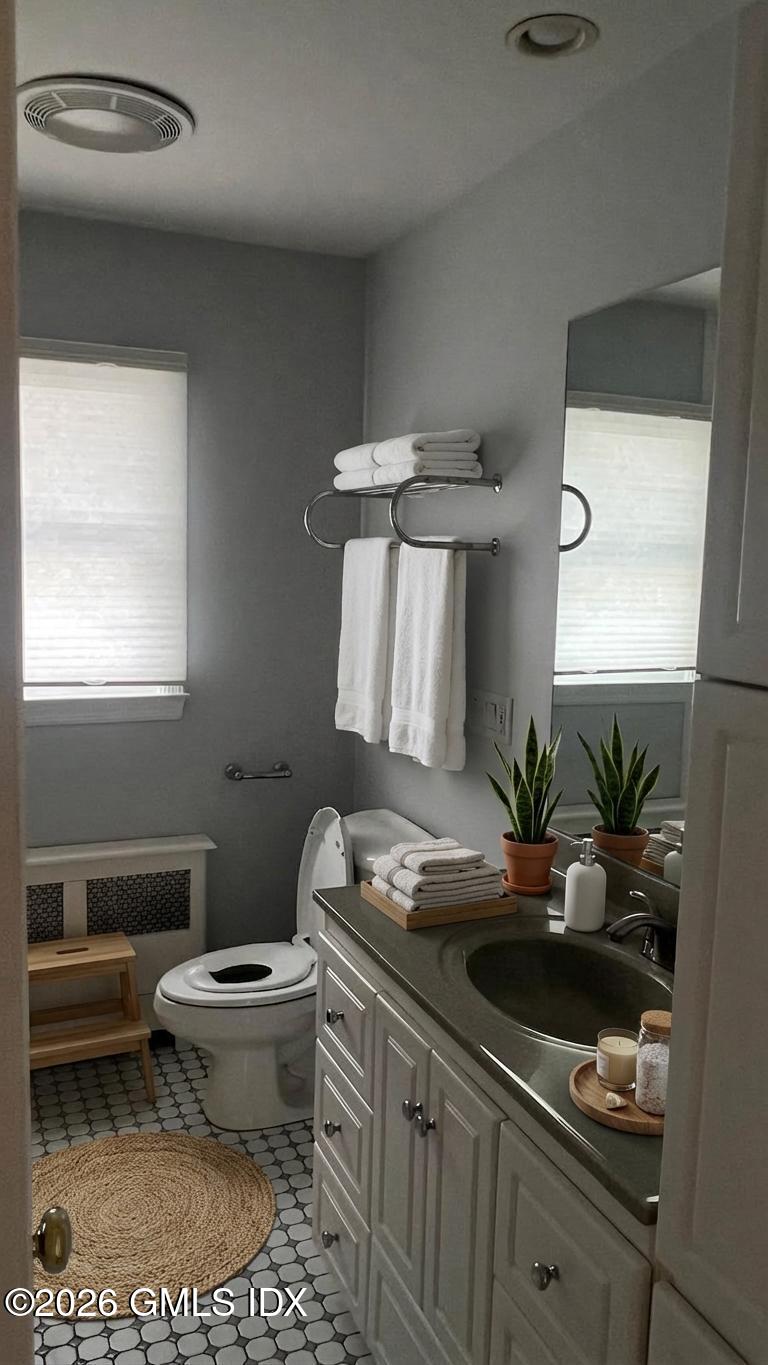 45 Sound Beach Ave Extension Riverside, CT 06878 - Photo 7 of 11 a bath room with a toilet a sink and a mirror