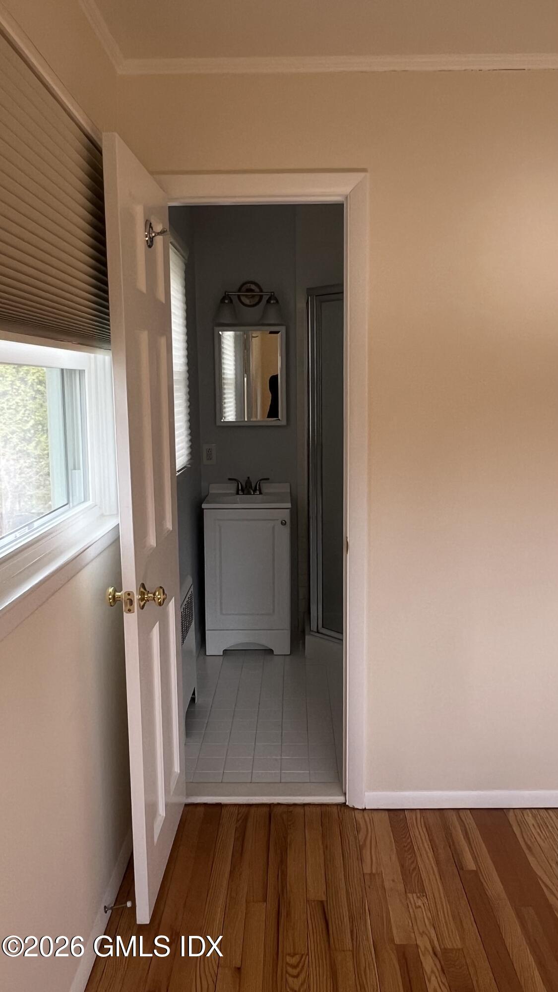 45 Sound Beach Ave Extension Riverside, CT 06878 - Photo 8 of 11 a view of a hallway with wooden floor and a living room