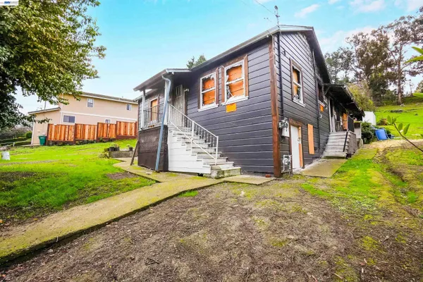 a view of a house with a yard and stairs