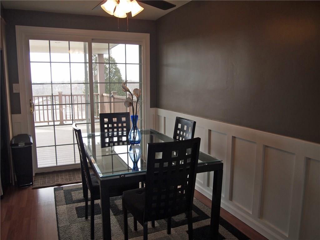 936 Lindsay Road Carnegie, PA 15106 - Photo 3 of 25 Laminate floors, wainscoting continue into dining room and kitchen. New slider accesses new deck.