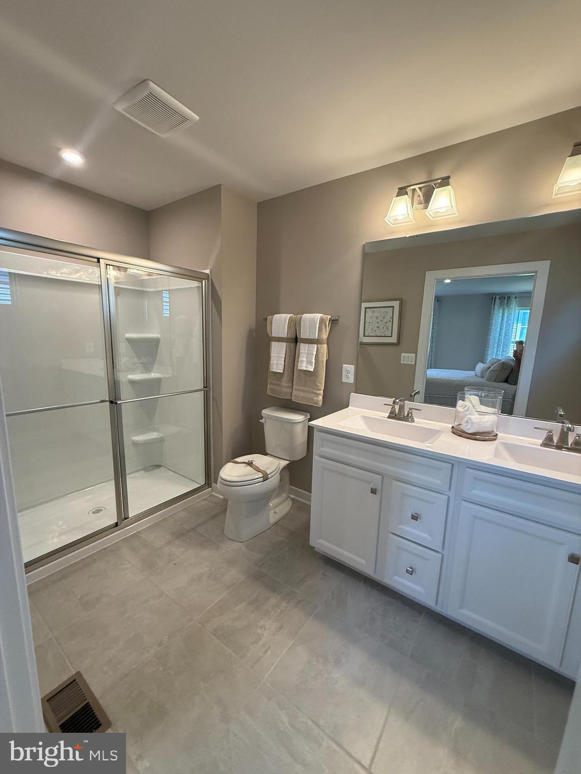 2506 Crown Point Circle Frederick, MD 21702 - Photo 12 of 21 a bathroom with a double vanity sink a toilet and a mirror
