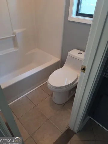 a bathroom with a toilet and a bathtub