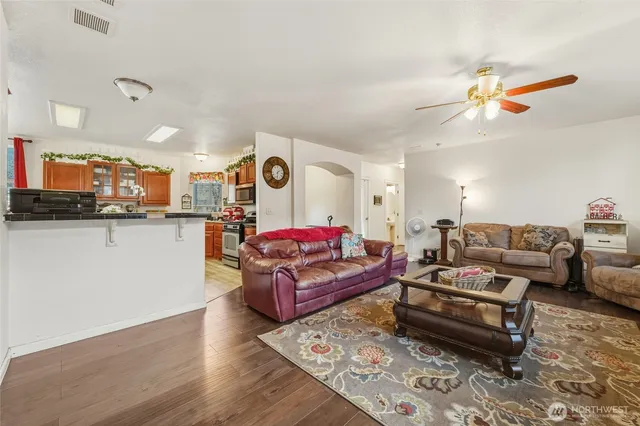 a living room with furniture and kitchen view