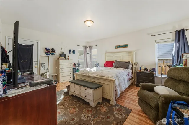 a bed room with furniture and a flat screen tv