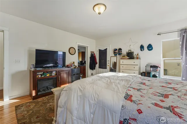 a bedroom with a bed and a flat screen tv
