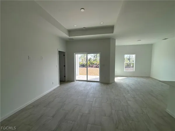 an empty room with windows and entrance