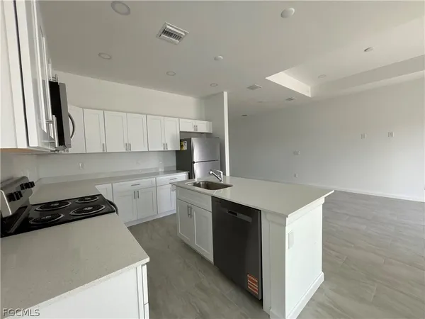 a kitchen that has a sink and a stove in it